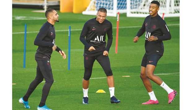 (From left) Paris Saint-Germainu2019s Layvin Kurzawa, Kylian Mbappe and Presnel Kimpembe attend a training session at the Camp des Loges in Saint-Germain-en-Laye near Paris, France, yesterday. (AFP)