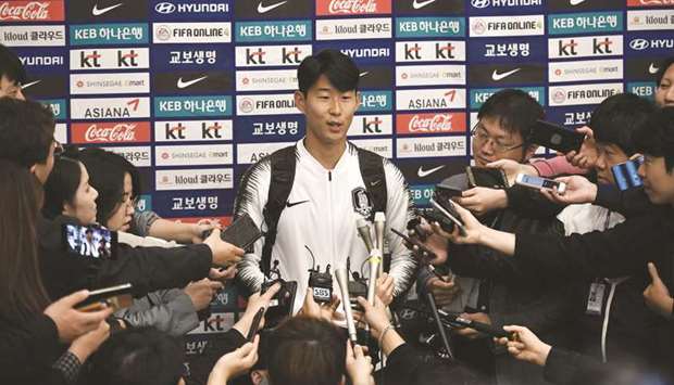 South Korean footballer Son Heung-min speaks to the media upon his arrival in Incheon yesterday. (AFP)