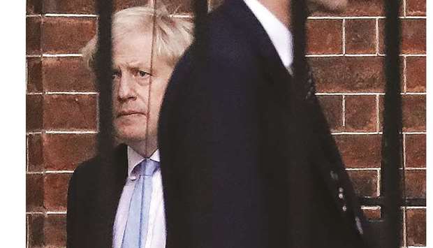 Prime Minister Boris Johnson leaves from the rear of 10 Downing Street in central London yesterday.