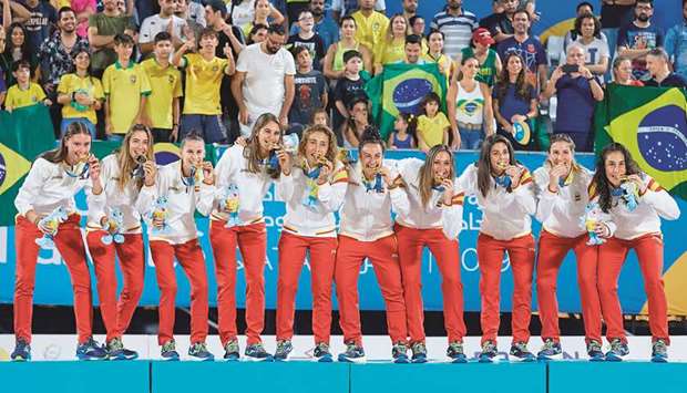 The Spanish team celebrate with their gold medals after winning the soccer competition.