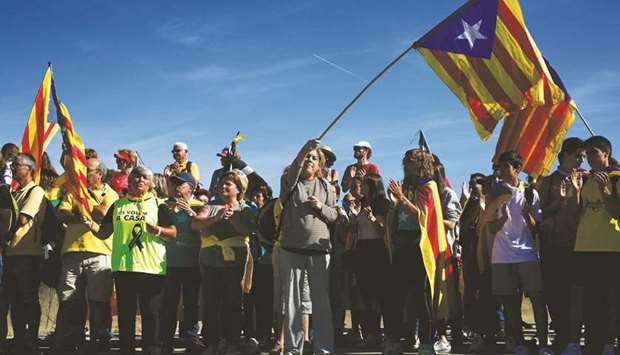 Protesters wave Catalan pro-independence u201cEsteladau201d flags as they march on the Nacional 2 road in Sils, near Girona, yesterday.