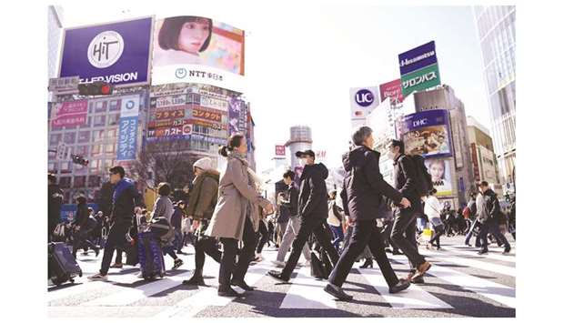 Pedestrians cross an intersection in the Shibuya district of Tokyo. Japanu2019s core consumer inflation slowed to near 2-1/2-year lows in September, dragged down by  sliding energy prices and raising the chance the central bank will top up its already massive monetary stimulus at its review this month.