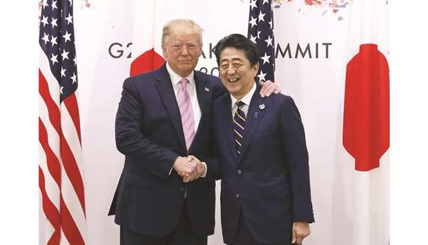 US President Donald Trump (left) shakes hands with Shinzo Abe, Japanu2019s prime minister, prior to a bilateral meeting at the Group of 20 summit in Osaka, Japan. The trade deal reached between Japan and the US is estimated to contribute about u00a54tn ($36.81bn) to Japanu2019s gross domestic product based on its fiscal 2018 GDP, and the pact will create about 280,000 jobs in Japan, the Japanese government said yesterday.