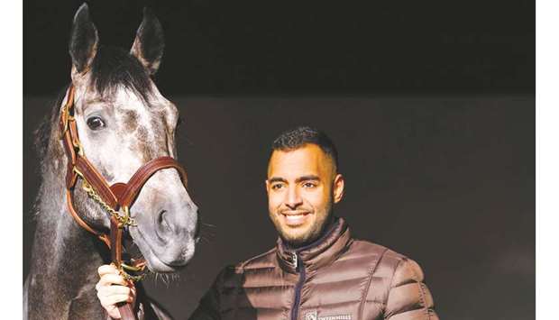 In this November 15, 2018, picture, Sheikh Fahad al-Thani smiles with Roaring Lion in the stables at Tweenhills, near Gloucester, England. (AFP)