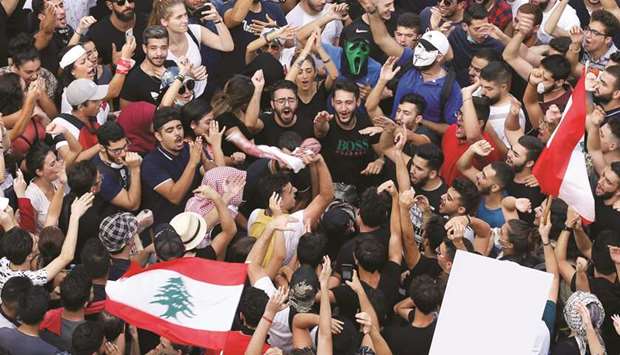 Demonstrators gesture and chant slogans during a protest over the deteriorating economic situation, in Beirut, yesterday.