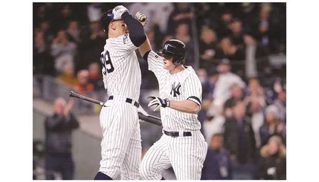 New York Yankeesu2019 DJ LeMahieu (right) is congratulated by Aaron Judge after the former hit a home run against the Houston Astros during the first inning of game five of the 2019 ALCS playoff baseball series in Bronx, United States, on Friday. (USA TODAY Sports)