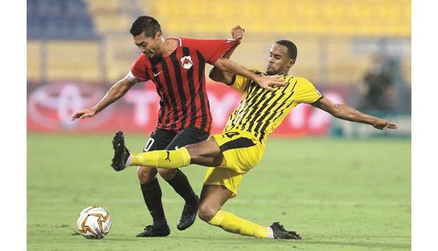 Rodrigo Tabata of Al Rayyan (left) tries to get past a Qatar Sports Club player.