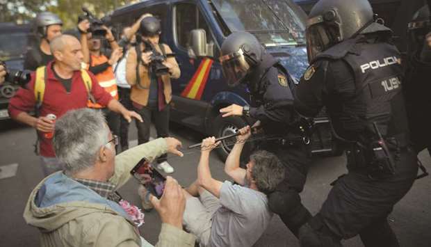 Spanish national police personnel clash with protesters yesterday during a demonstration called by the Catalan pro-independence youth group u2018Arranu2019 in Barcelona, a day after nearly 200 people were hurt in another night of violent clashes in Catalonia.