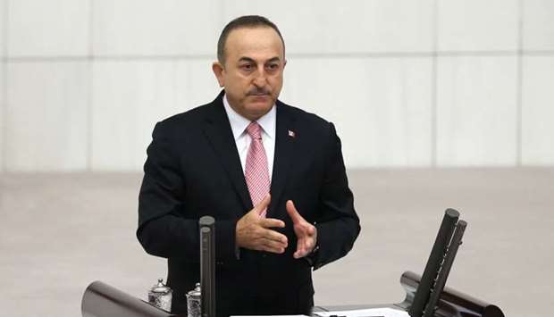 Turkish Foreign Minister Mevlut Cavusoglu addresses lawmakers at the parliament in Ankara, Turkey, October 16, 2019