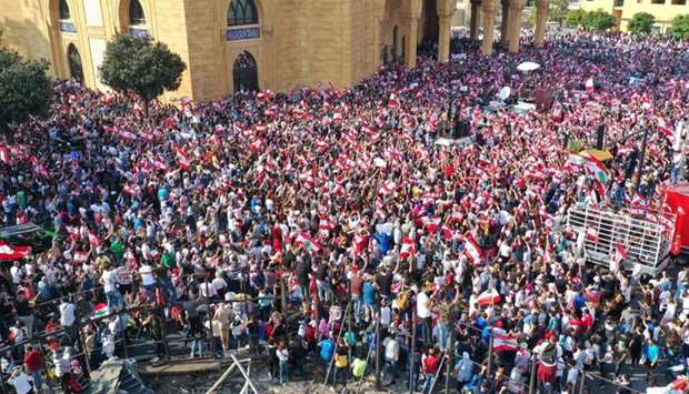 Lebanese protesters rallying in downtown Beirut on the fourth day of demonstrations against tax increases and official corruption