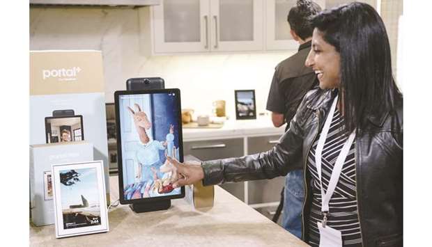 An employee demonstrates the Portal+ device during a Facebook product launch in San Francisco, California, on September 17. The star attraction of this product line is its wide-angle video camera, which can automatically follow a person and zoom in on them as they move around a room during a chat.