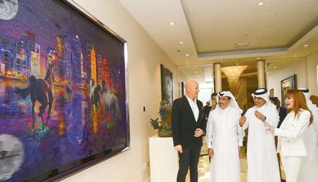 Interior designer Marieux van den Broek and special guests Beverly Hills Real Estate chairman Sheikh Khaled bin Nasser bin Hamad al-Thani and Regency Group Holding president Ibrahim Hassan al-Asmakh admire one of the art pieces on display. PICTURE: Jayan Orma.