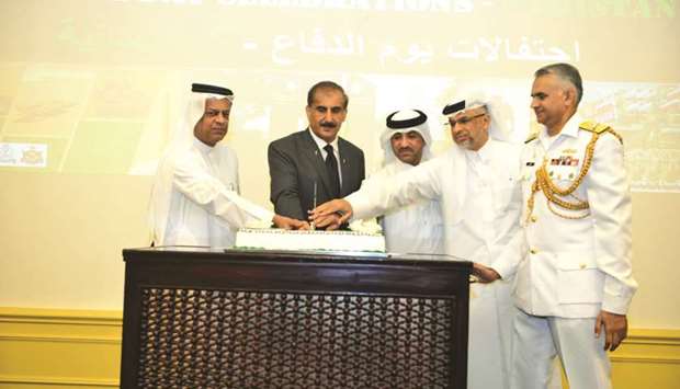 Qatari dignitaries join Pakistan ambassador to cut a cake at the event yesterday.