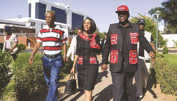 Botswana President Mokgweetsi Masisi (right) and First Lady Neo J Masisi arrive to address a gathering of BDP Gaborone regional candidates and members for the general election in Gaborone.