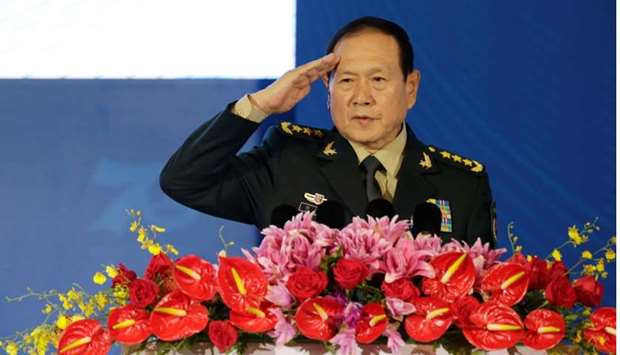 Chinese Defense Minister Wei Fenghe salutes before a speech at the Xiangshan Forum in Beijing