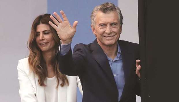 Argentinian President Mauricio Macri waves next to his wife Juliana Awada during a campaign rally near the Obelisk, in Buenos Aires.