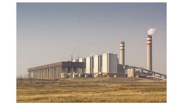 Emissions rise from the Eskom Holdings Kusile coal-fired power station in South Africa. Eskom, which supplies about 95% of the countryu2019s power, has $30.5bn of debt and is surviving on state bailouts after massive cost overruns at two partially completed coal-fired power plants.