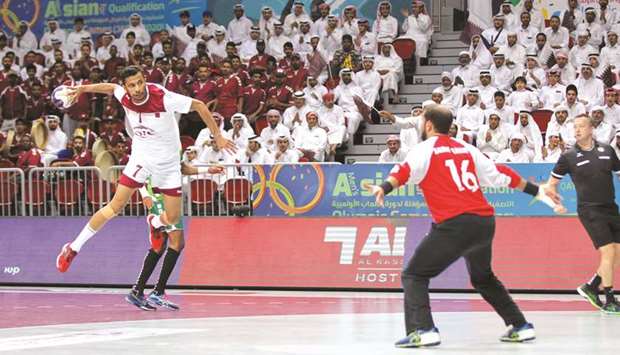 Qataru2019s Ahmed Madadi goes for a shot at goal against Saudi Arabia yesterday. Picture on right shows, high jump world champion Mutaz Barshim meeting Qatar handball players.