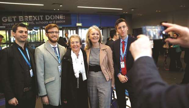 Secretary of State for International Trade Liz Truss poses for a picture with attendees at the venue for the Conservative Party annual conference in Manchester yesterday.