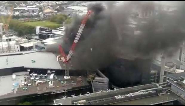 Smoke rises as a fire blazes at Sky City Convention Centre, which is under construction in Auckland, New Zealand