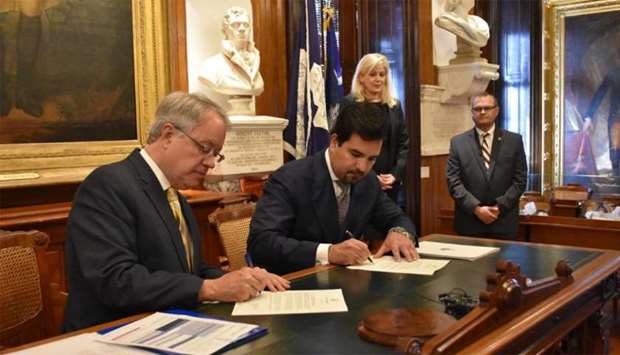 HE the ambassador of Qatar to the United States Sheikh Meshal bin Hamad al-Thani and Charleston Mayor John Tecklenburg signing the agreement.