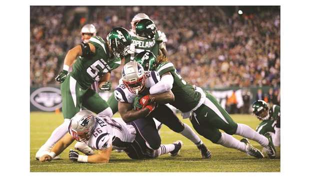 New England Patriots running back Sony Michel (centre) dives for a touchdown against New York Jets linebacker CJ Mosley (right) during the second quarter of their NFL game at MetLife Stadium in East Rutherford, United States, on Monday. (USA TODAY Sports)