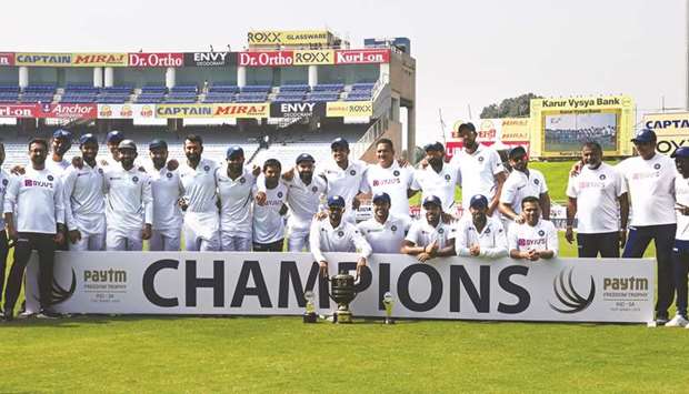 Indian team and support staff pose with the trophy after winning the third and final Test match against South Africa at the Jharkhand State Cricket Association stadium in Ranchi yesterday. (AFP)