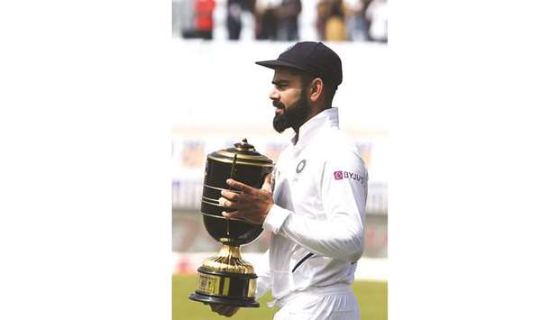 Indiau2019s captain Virat Kohli with the trophy in Ranchi. (AFP)