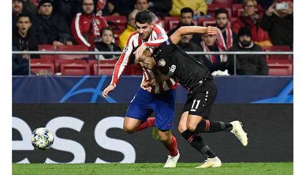 Atletico Madridu2019s Alvaro Morata (left) vies for the ball with Bayer Leverkusenu2019s Nadiem Amiri during the UEFA Champions League Group D match in Madrid yesterday. (AFP)