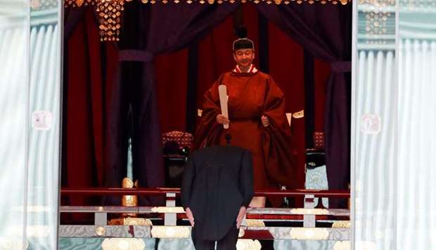 Japan's Prime Minister Shinzo Abe bows in front of Emperor Naruhito during a ceremony to proclaim his enthronement to the world, called Sokuirei-Seiden-no-gi, at the Imperial Palace in Tokyo