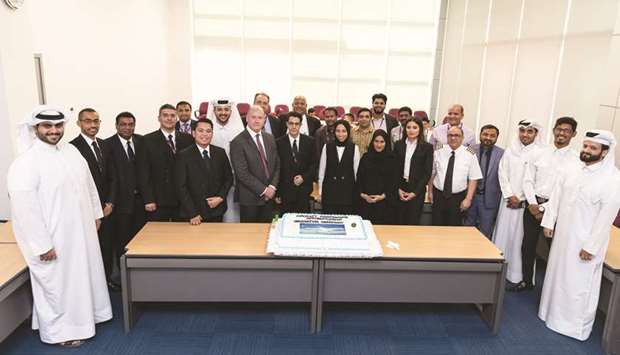 Graduates from Qatar Airwaysu2019 Aircraft Mechanic Apprenticeship programme with officials during the graduation ceremony.