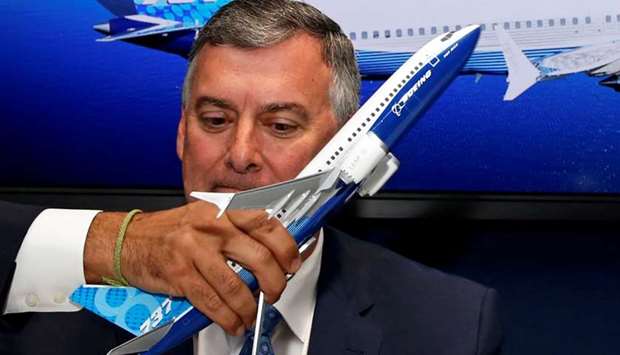 A model of a Boeing 737 MAX is held in front of Kevin McAllister, Boeing Commercial Airplanes CEO, during a commercial announcement at the 53rd International Paris Air Show at Le Bourget Airport near Paris, France June 18, 2019