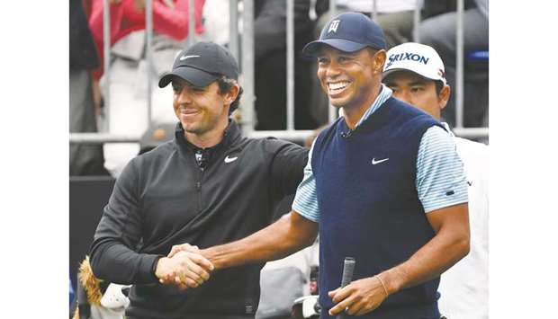 Tiger Woods (right) shakes hands with Rory McIlroy during the u201cJapan Skinsu201d pre-match at the Narashino Country Club in Inzai, Chiba, Japan, on Monday. (AFP)