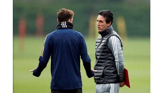 Arsenal manager Unai Emery and Mesut Ozil during training at St. Albans, England.