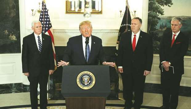 US President Donald Trump delivers a statement on the conflict in Syria as Vice President Mike Pence, Secretary of State Mike Pompeo and White House National Security Adviser Robert Ou2019Brien stand by in the Diplomatic Room of the White House in Washington, yesterday.