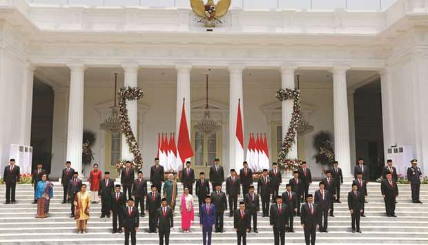 Indonesian President Joko Widodo, Vice President Mau2019ruf Amin, and newly appointed cabinet ministers pose for photographers after the ministersu2019 inaugurations for Widodou2019s second term, at the Presidential Palace in Jakarta, yesterday.