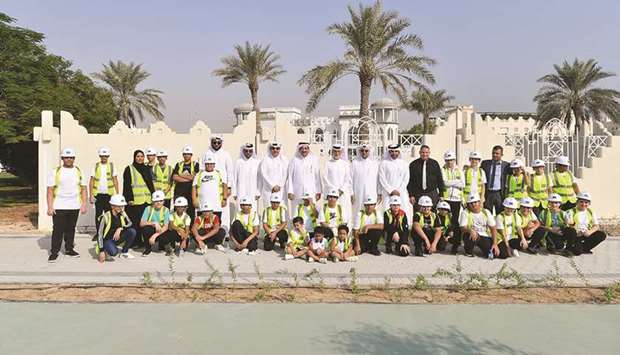 Students with Ashghal officials during the u2018Qatar Beautification and Our Kids Planting Treesu2019 campaign.