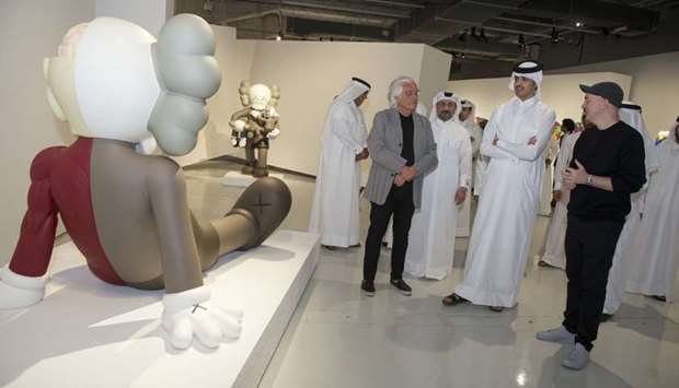 HE Sheikh Thani bin Hamad bin Khalifa al-Thani touring the 'Kaws: He Eats Alone' exhibition at the Doha Fire Station on Thursday along with the featured artist Brian Donnelly, known professionally as Kaws, and other dignitaries.