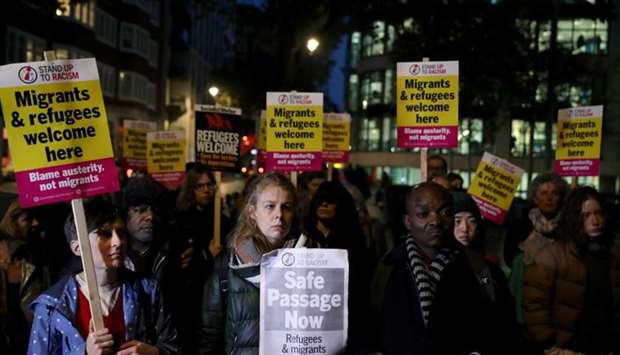 Anti-racism campaigners take part in a vigil, following the discovery of 39 bodies in a truck container on Wednesday, outside the Home Office in London
