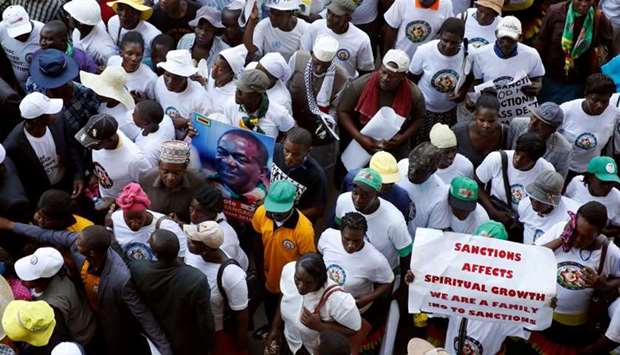 Government supporters chant slogans as they march against Western sanctions at a rally in Harare, Zimbabwe