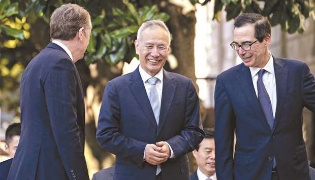 Liu He, Chinau2019s vice premier (centre), talks to Robert Lighthizer, US trade representative (left), and Steven Mnuchin, US Treasury secretary in Washington (file). The two sides are working to try to agree on a text for a u201cPhase 1u201d trade agreement announced by US President Donald Trump on October 11, in time for him to sign it with Chinau2019s President Xi Jinping next month at a summit in Chile.