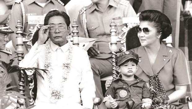 File photo taken on November 15, 1985 shows then president Ferdinand Marcos and his wife Imelda appearing before some 35,000 college students undergoing a two-year compulsory military training in Manila.