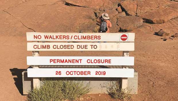 A new permanent closure sign is installed at Uluru, formerly known as Ayers Rock, the day before a permanent ban on climbing the monolith takes effect following a decades-long fight by indigenous people to close the trek, near Yulara, Australia, yesterday.