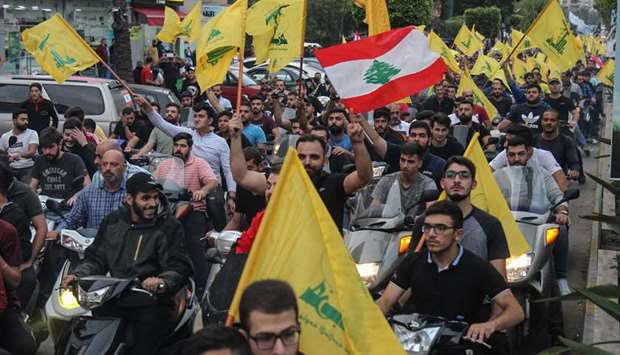 Supporters of the Hezbollah movement drive in a convoy in support of its leader Hassan Nasrallahu2019s speech, in the southern suburbs of Beirut, yesterday.