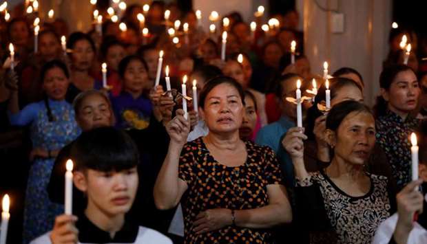 Catholics attend a mass prayer for 39 people found dead in the back of a truck near London, UK at My Khanh parish in Nghe An province, Vietnam