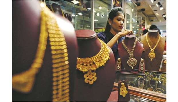 A salesperson is seen inside a jewellery showroom in Mumbai. Gold sales on the most auspicious day in India to buy the metal tumbled this year as high prices and  concerns about an economic slowdown saw customers limit purchases.
