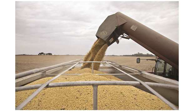 Soybeans are unloaded from a harvester in Illinois. China aims to buy at least $20bn of agricultural products in a year if it signs a partial trade deal with the US, and would consider boosting purchases further in future rounds of talks, people familiar with the matter said.