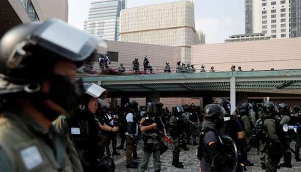 Police officers stand guard during an anti-government protest in Hong Kong's tourism district of Tsim Sha Tsui