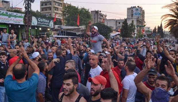 Lebanese anti-government protesters shout slogans during a demonstration in Beddawi town on the outskirts of the northern Lebanese port city of Tripoli
