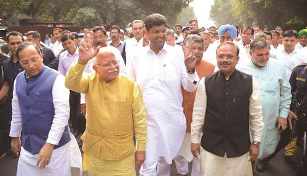 Khattar and Chautala show the victory sign as they along with Law Minister Ravi Shankar Prasad and BJP general secretary Arun Singh arrive to meet Governor Satyadeo Narain Arya in Chandigarh yesterday.